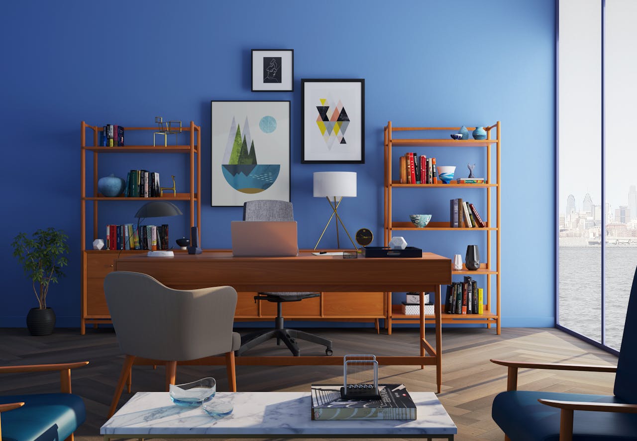 Home Elegantly decorated home office with modern furniture and a blue wall.